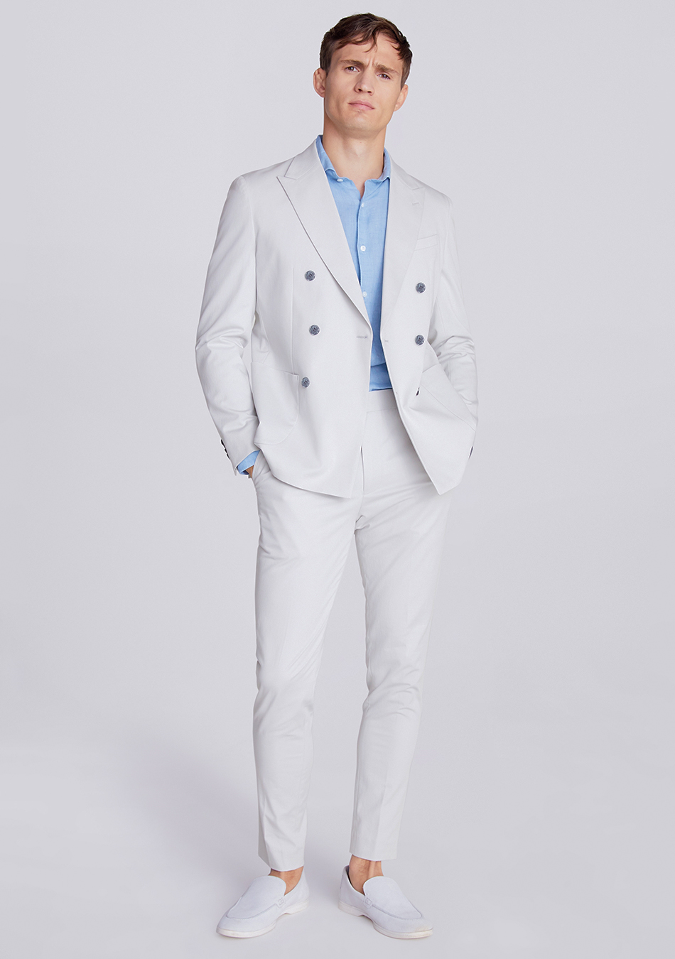 Light grey cotton suit, blue dress shirt, and white loafers