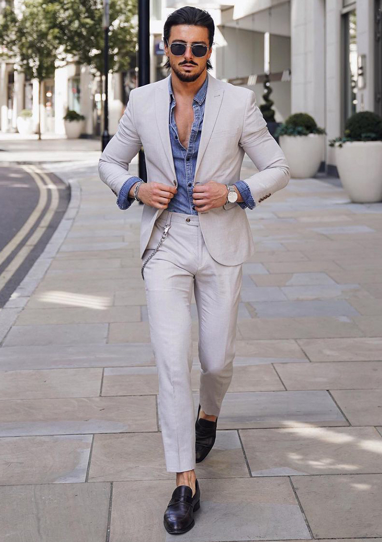 Light grey suit, blue denim shirt, and black loafers