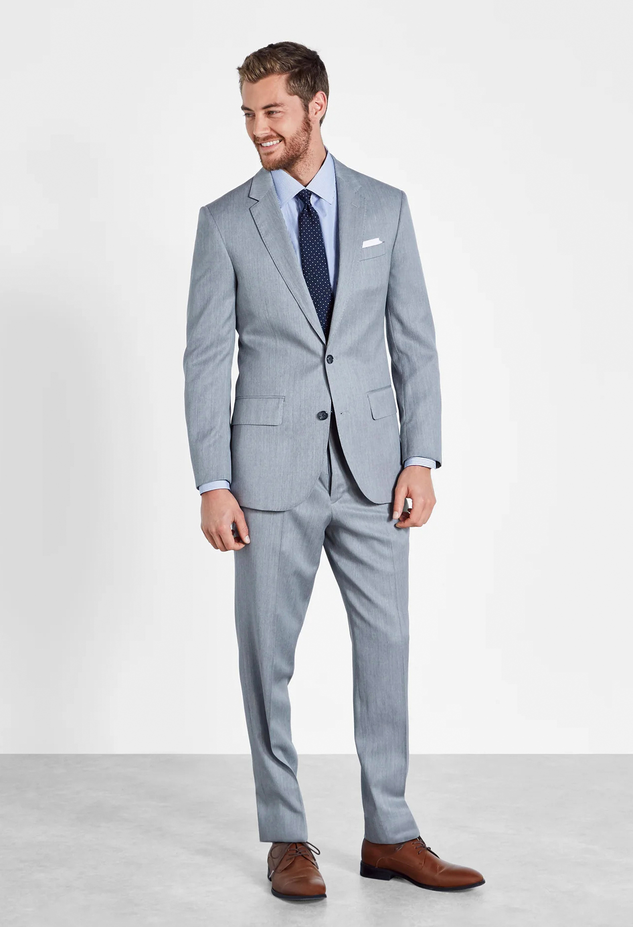 Light grey suit, light blue dress shirt and navy polka dot tie