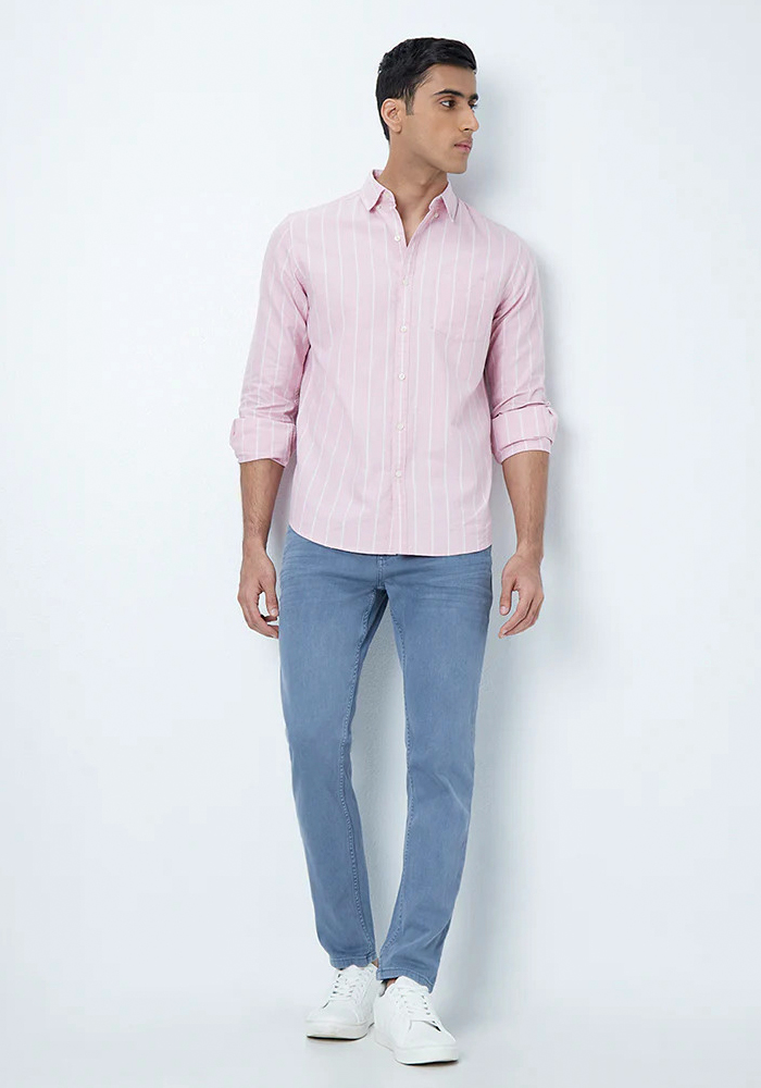 Light pink striped shirt, light blue jeans, and white sneakers