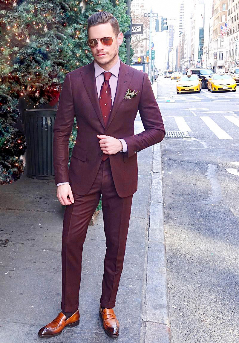 Maroon suit with a light pink shirt and brown penny loafers