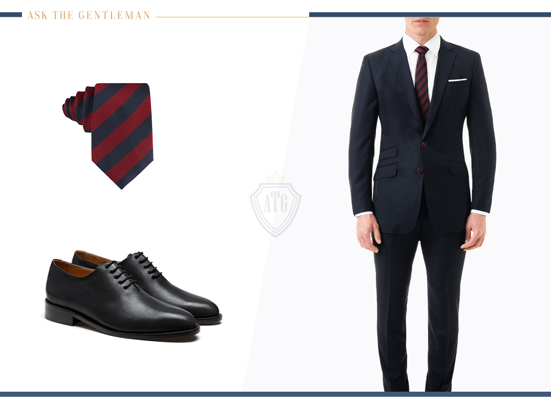 Matching a midnight blue suit with a dark red tie and black Oxford shoes