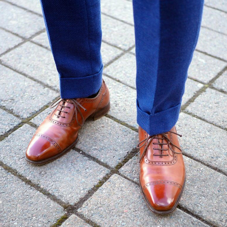 matching blue pants with light brown brogue oxford shoes