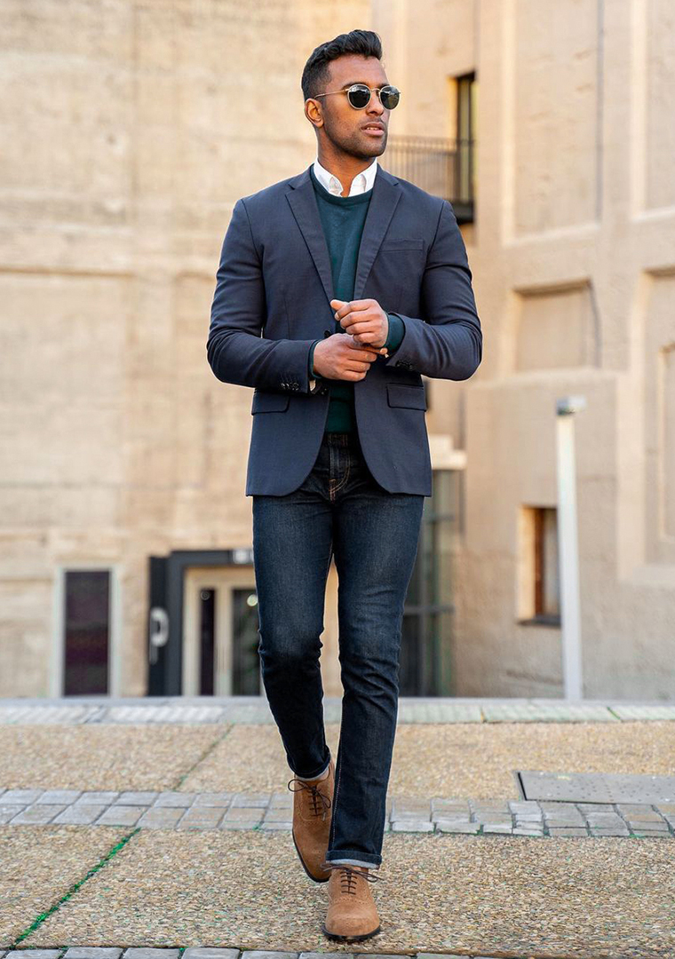 Navy blue blazer and a blue crew neck sweater over a white shirt