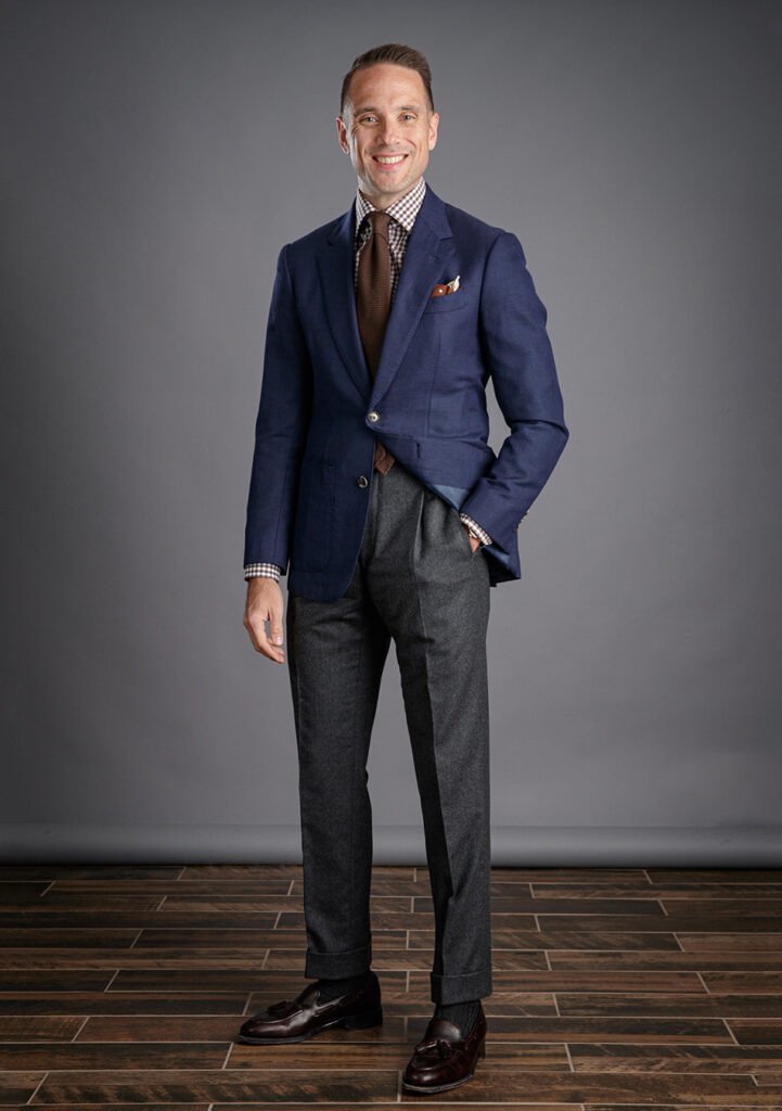 Navy blazer and grey pants with a brown gingham shirt and tie