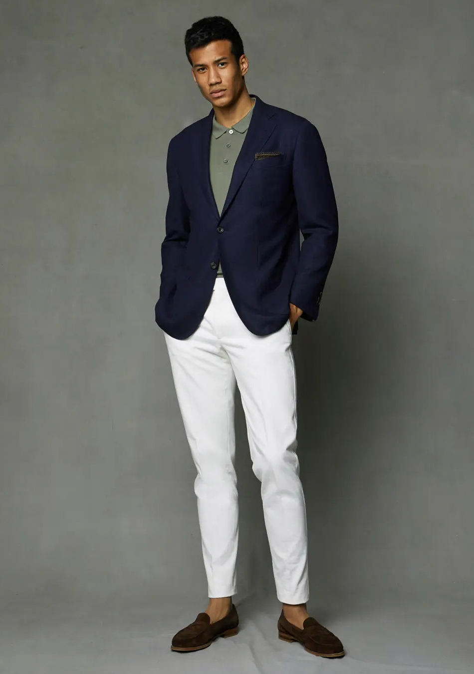 Navy blazer, olive green polo shirt, white pants, and brown suede loafers
