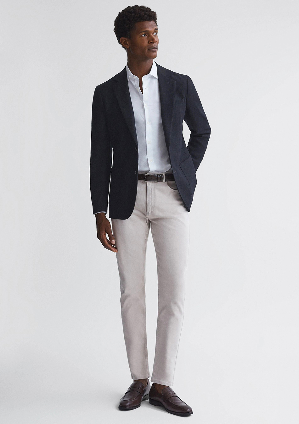 Navy blazer, white dress shirt, light grey jeans, and brown loafers