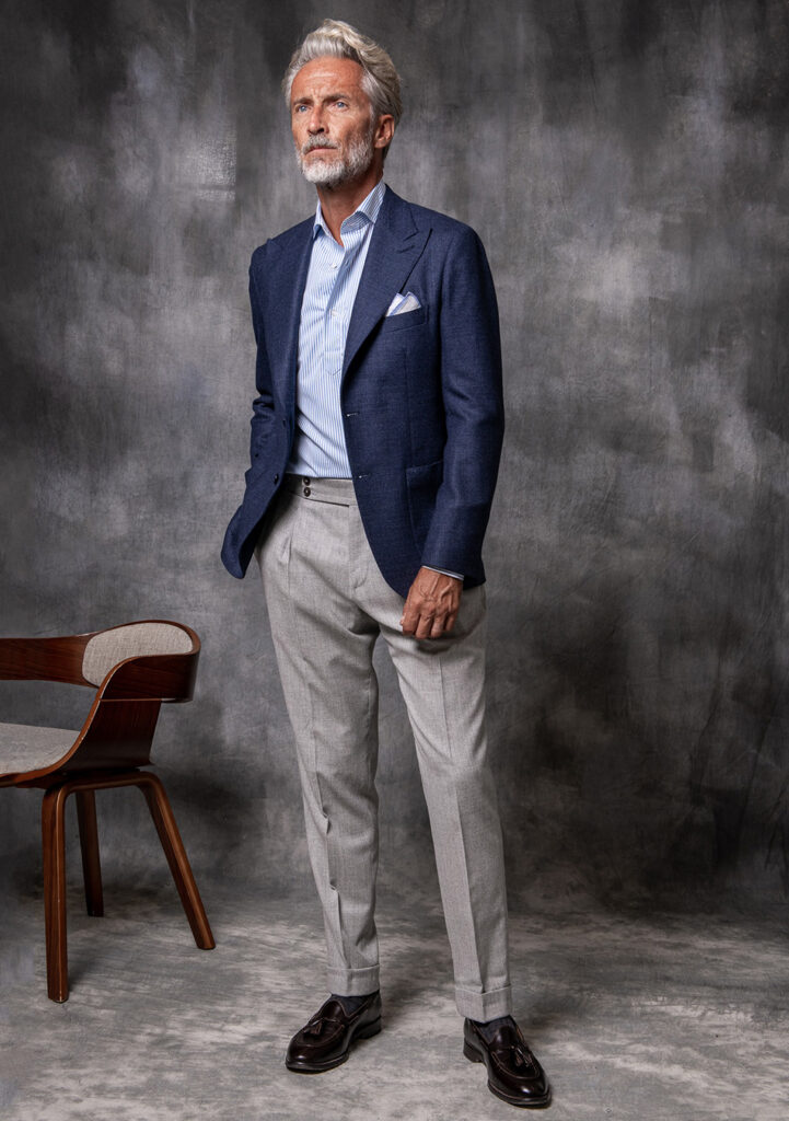 Navy blue blazer, blue striped tie, and grey pants