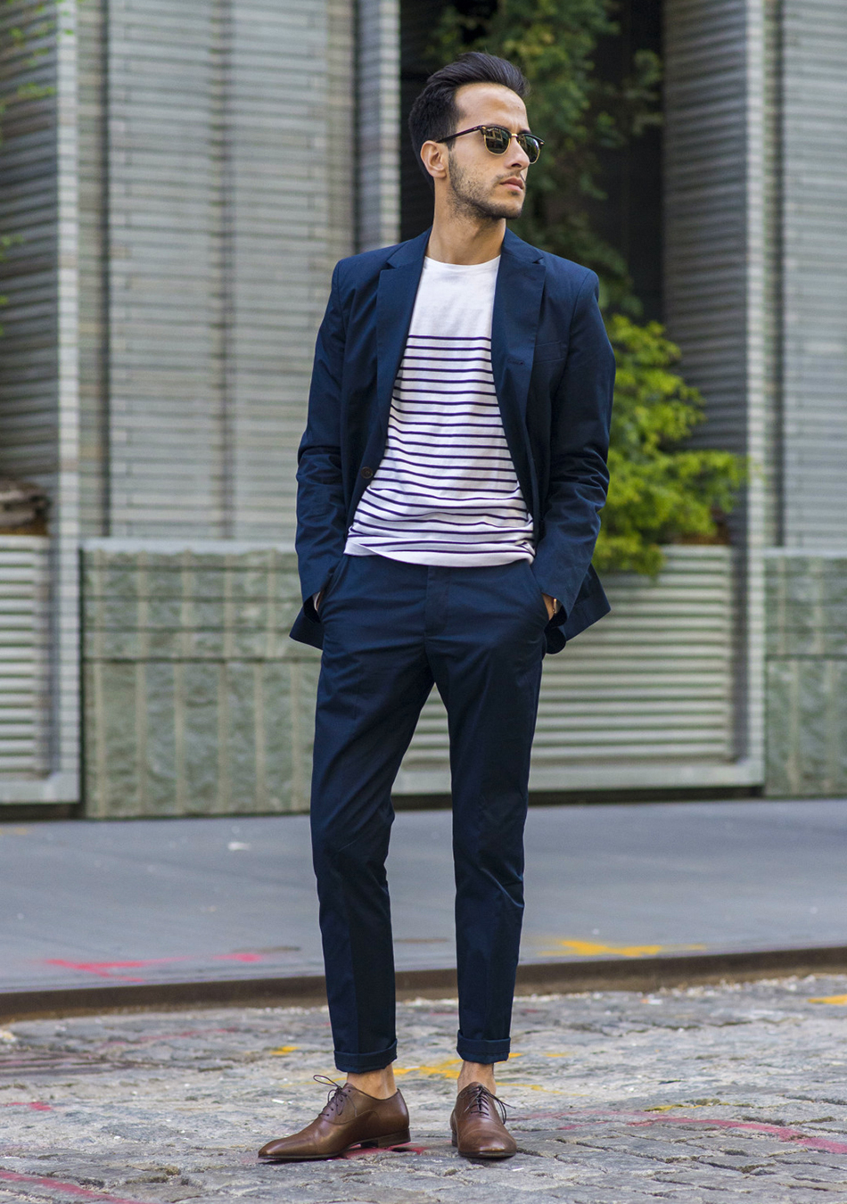 Navy blue suit, white t-shirt, and brown oxford shoes