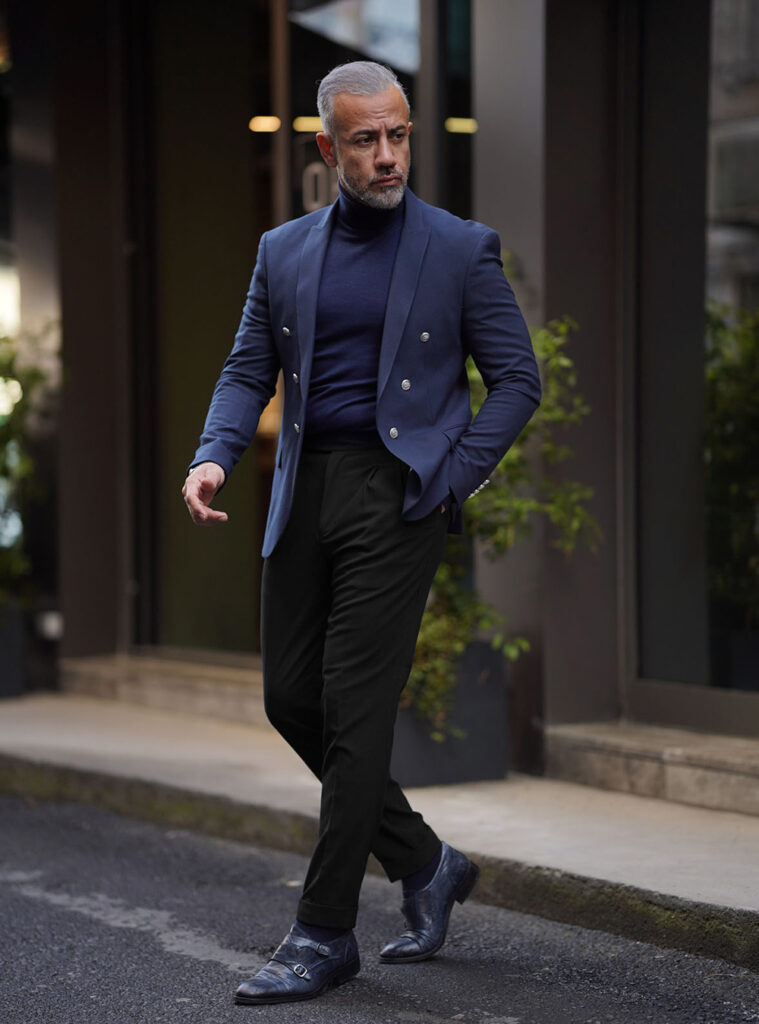 Navy double-breasted blazer, navy turtleneck, and black pants