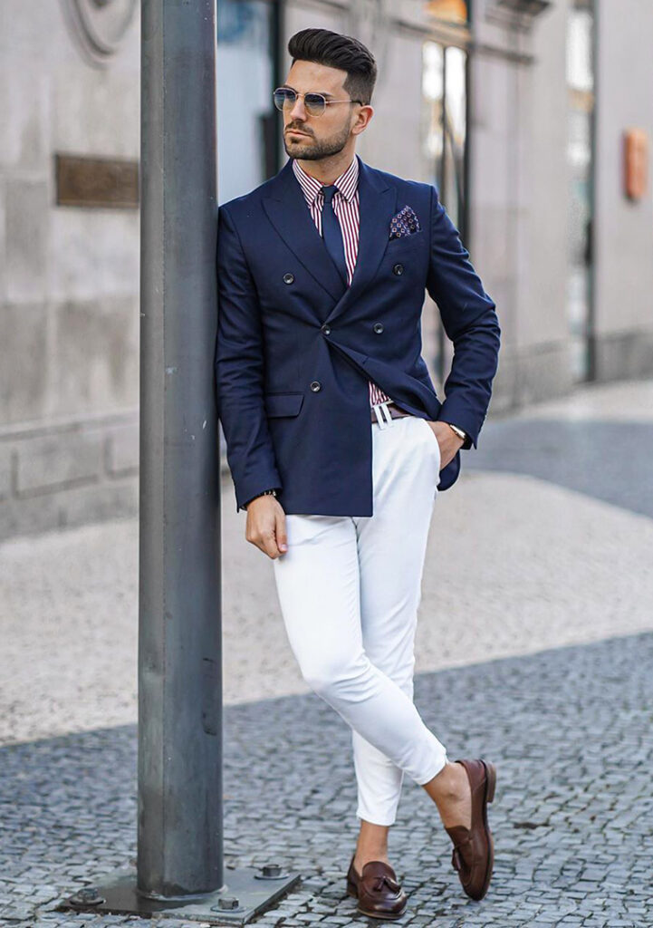 Navy blazer, pink striped shirt, white pants, and brown loafers