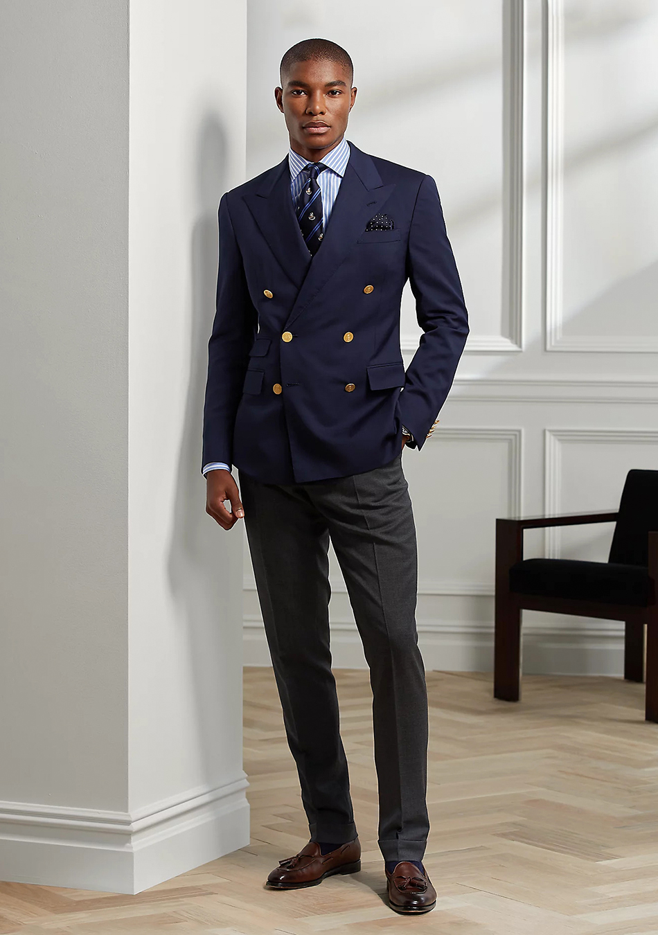 Navy double-breasted blazer with charcoal pants and brown loafers
