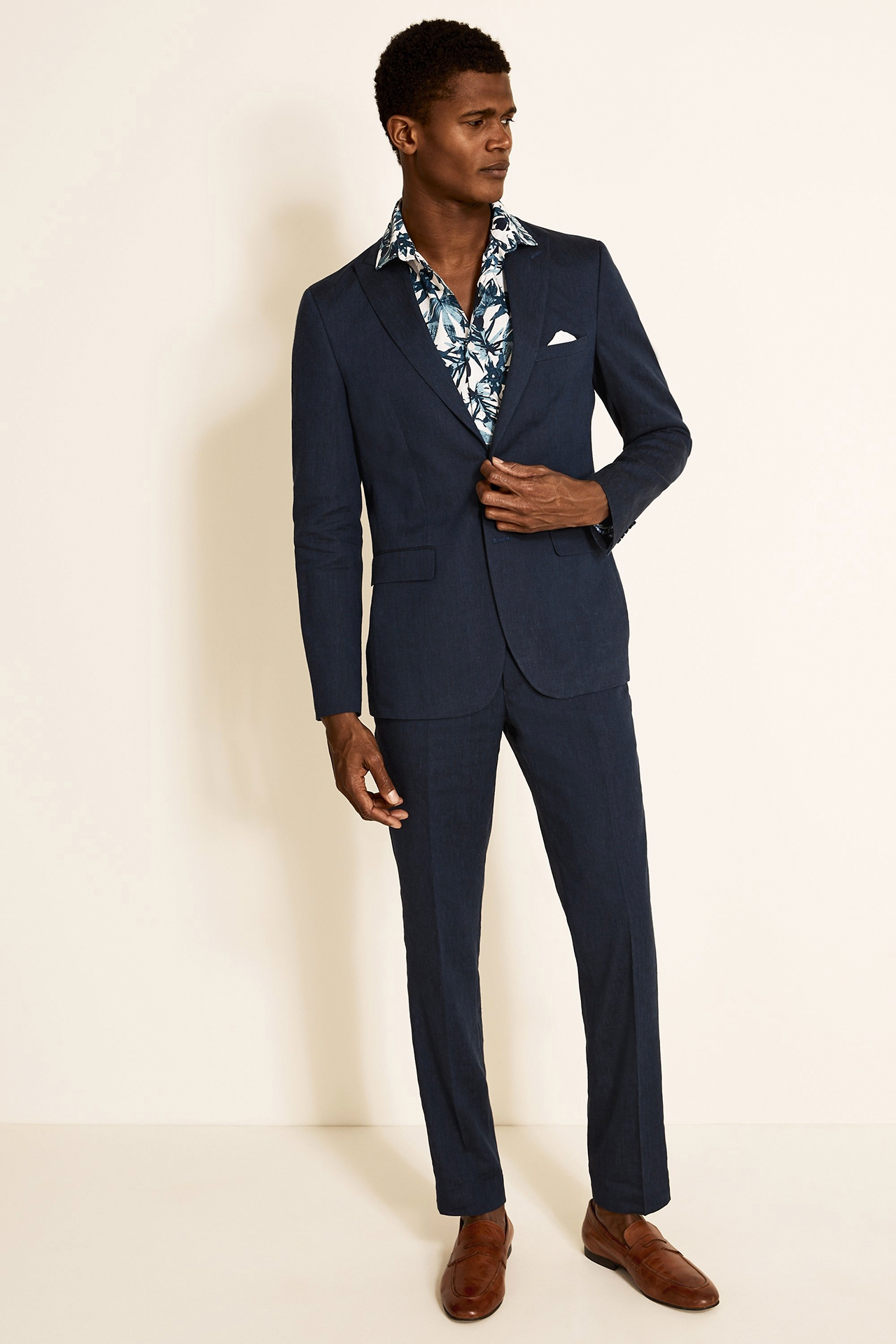 Navy linen suit, blue floral shirt, and brown loafers