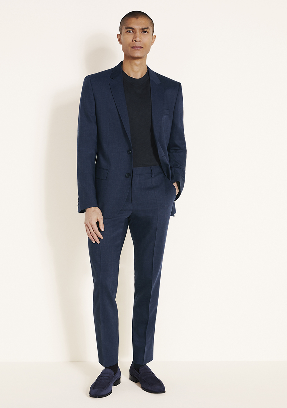 Navy suit, black t-shirt, and navy blue loafers