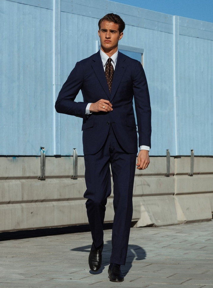 Navy suit, blue dress shirt, and brown tie color combination