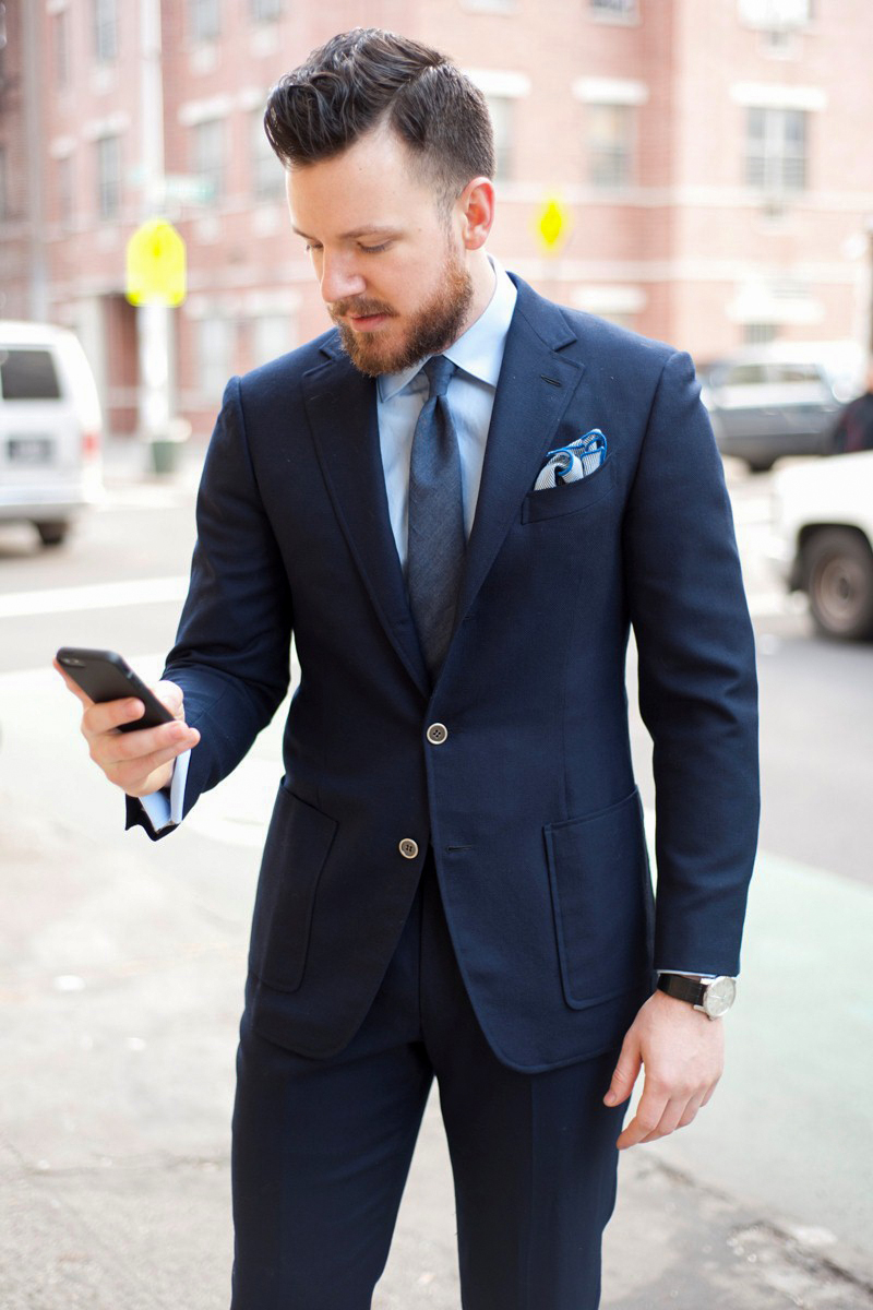 Formal job interview outfit: navy blue suit, light blue shirt, and mid-blue tie