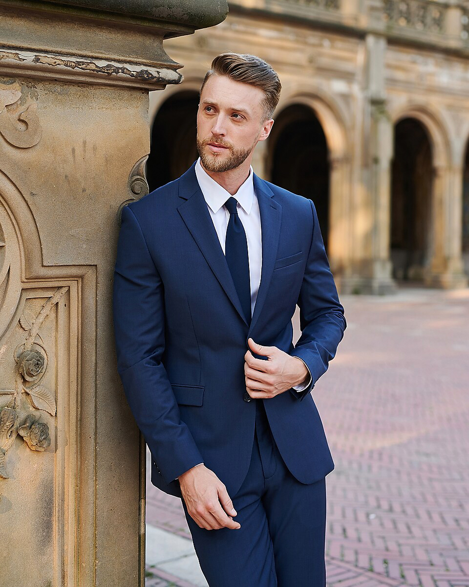 Slim-fit navy suit with a white shirt and solid navy tie