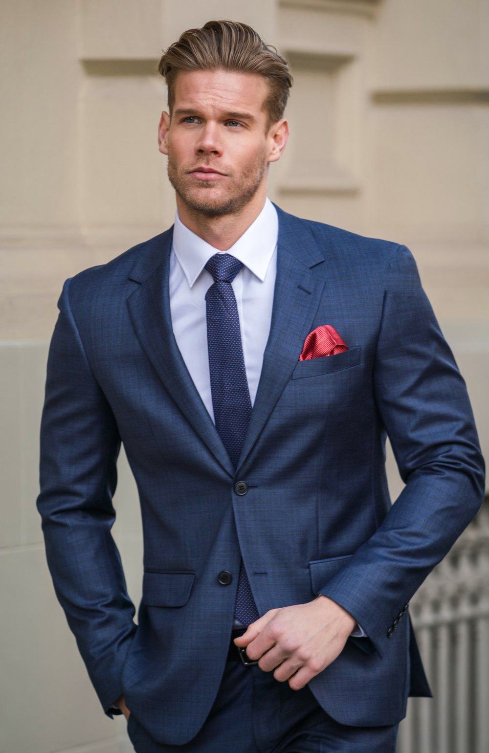 Navy suit with white dress shirt and dark blue tie