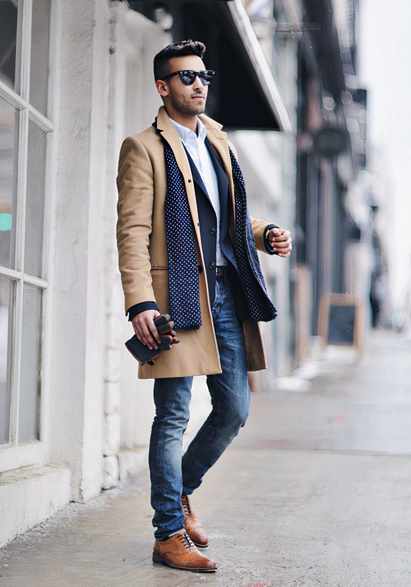 Tan overcoat over a white dress shirt and blue jeans