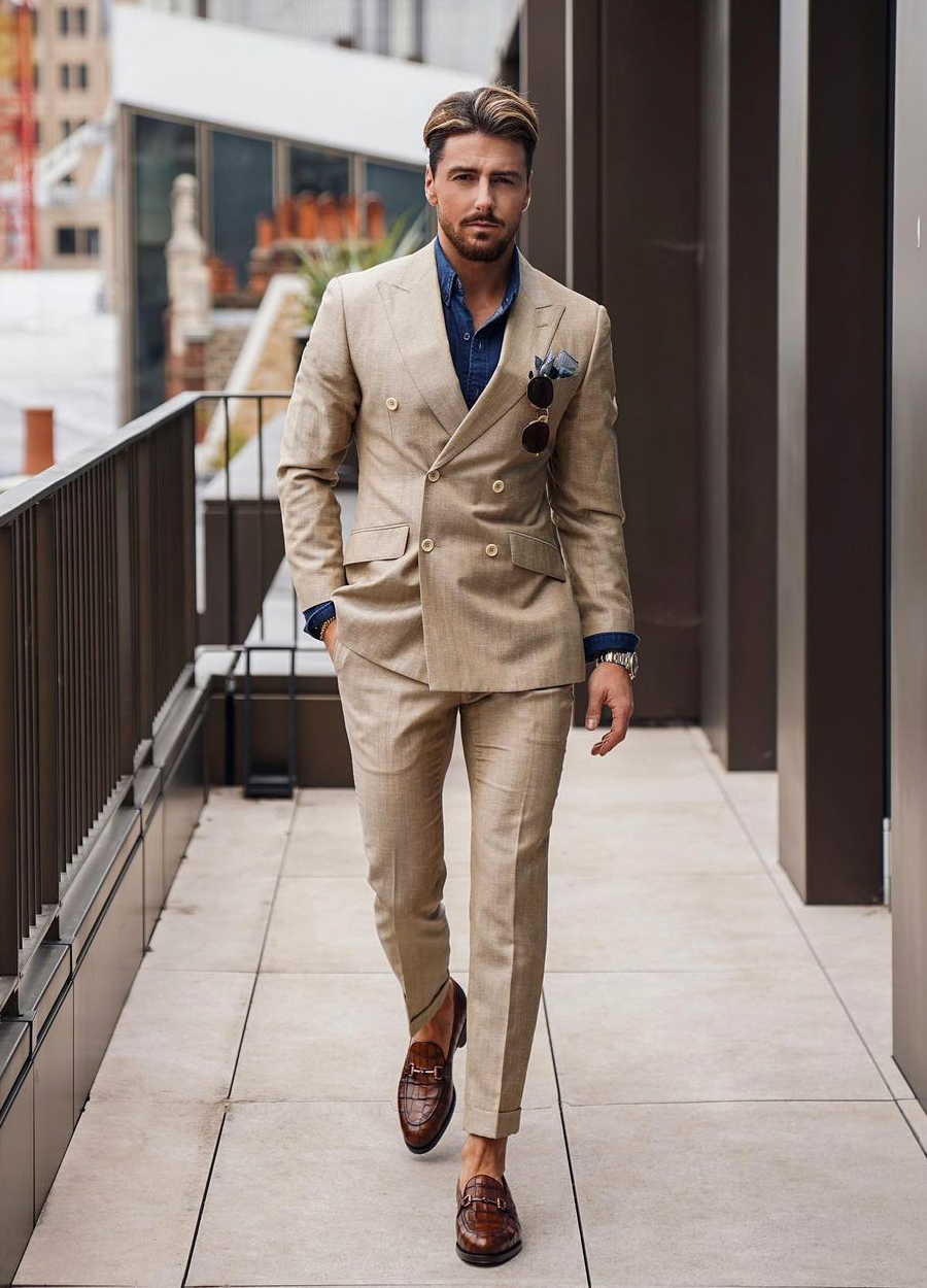 Tan suit, blue denim shirt, and brown loafers