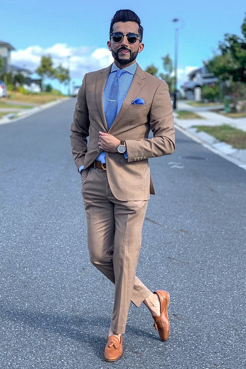 Tan suit, blue striped shirt, and bright blue tie