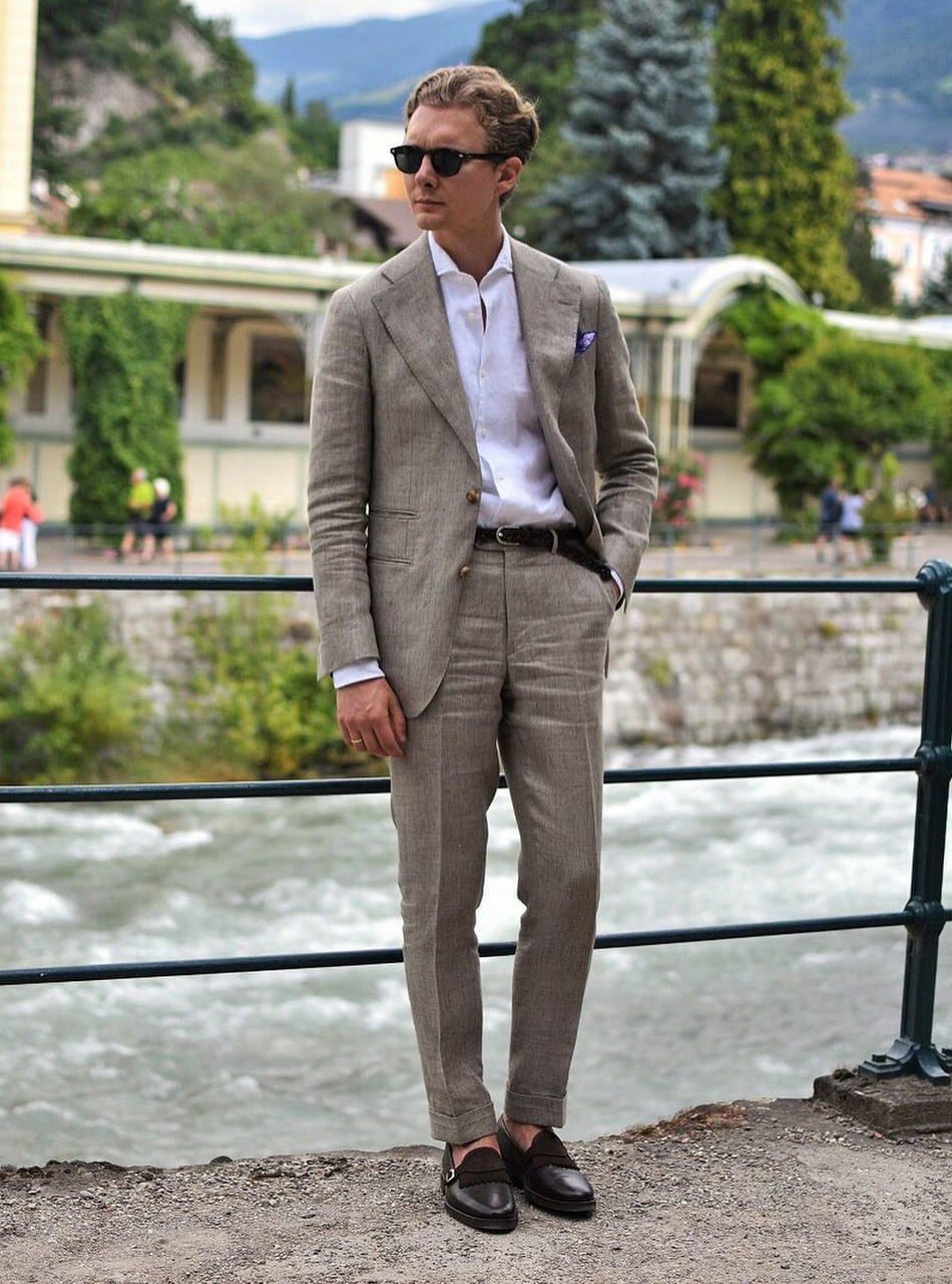 Tan suit with white shirt and black penny loafer shoes