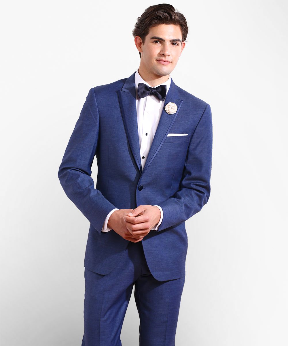 Wearing a blue suit with a white dress shirt and a navy bow tie formally
