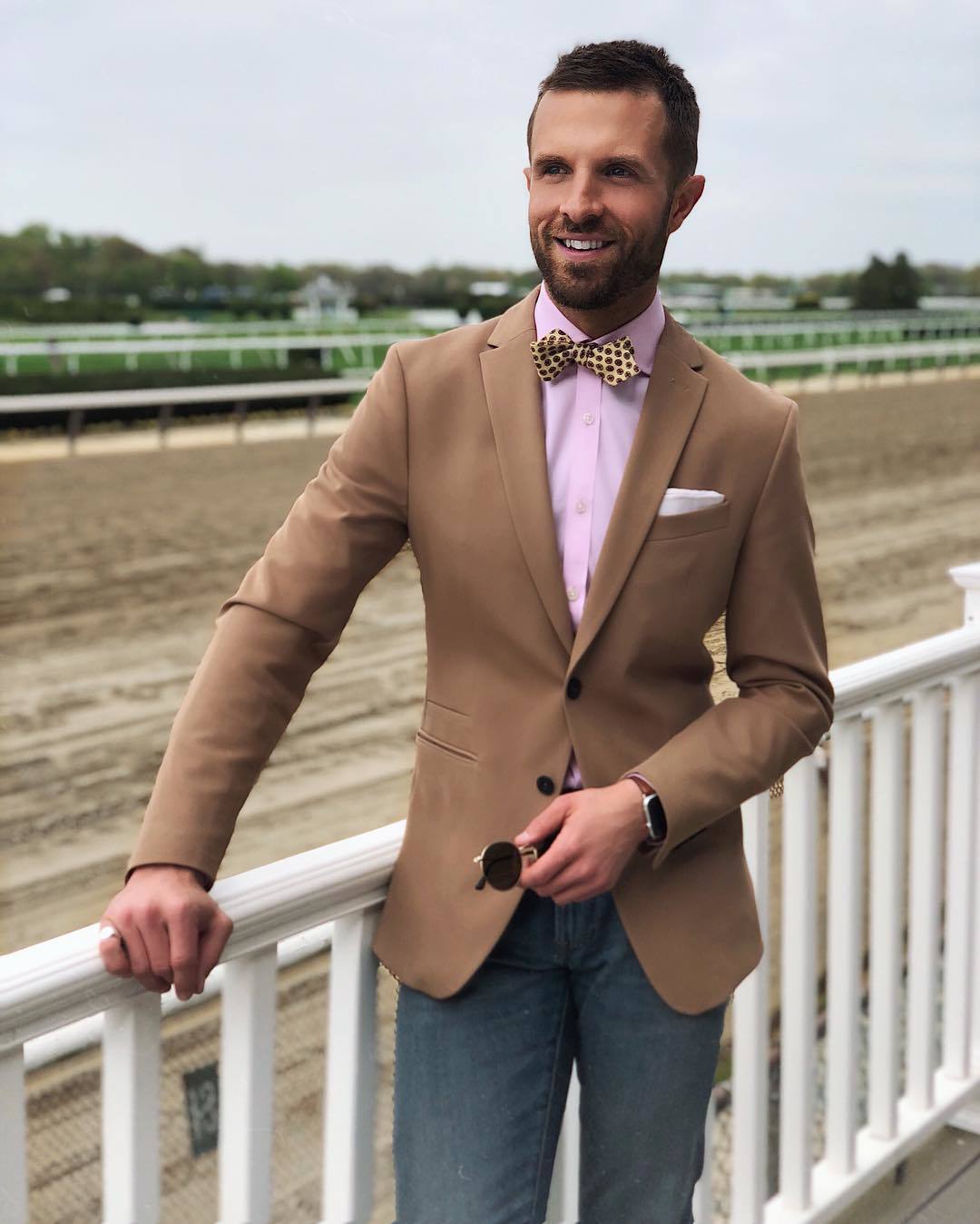 Wearing a brown blazer with pink shirt and jeans casually