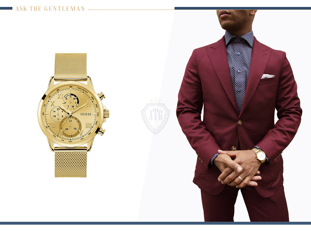 Weearing a gold metal watch with a maroon suit