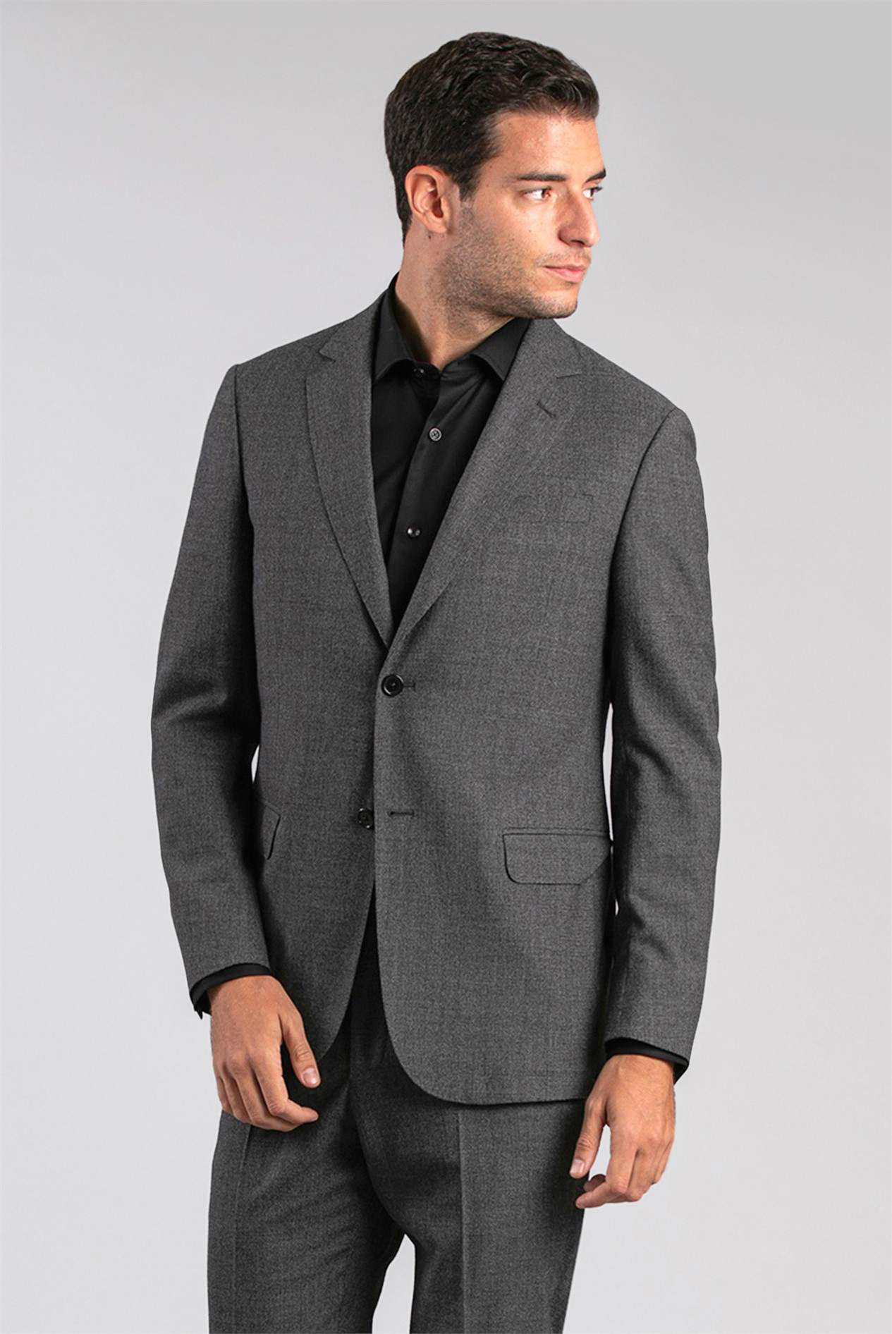 Wearing a grey suit with a black dress shirt
