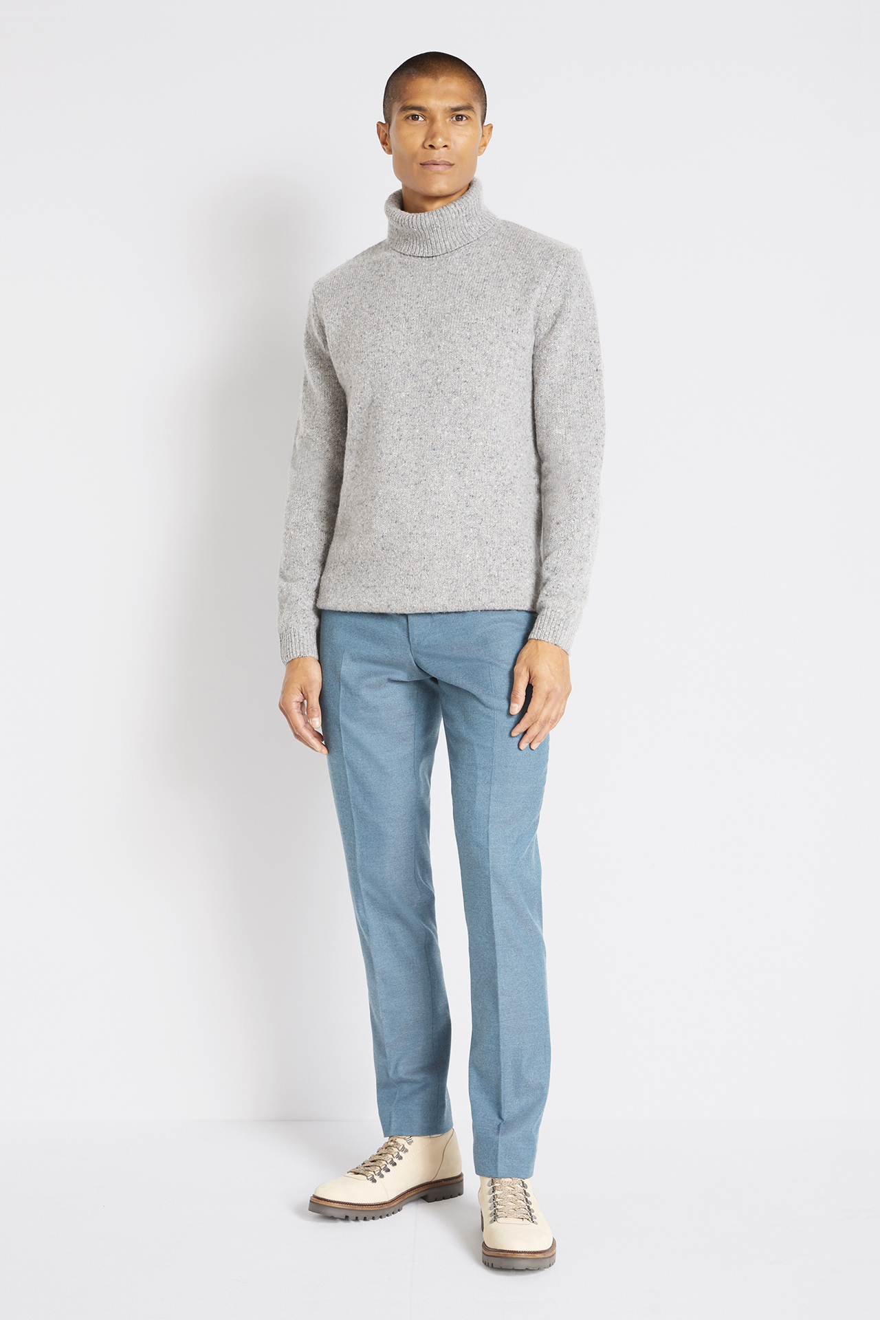 Wearing a grey turtleneck with a light blue jeans