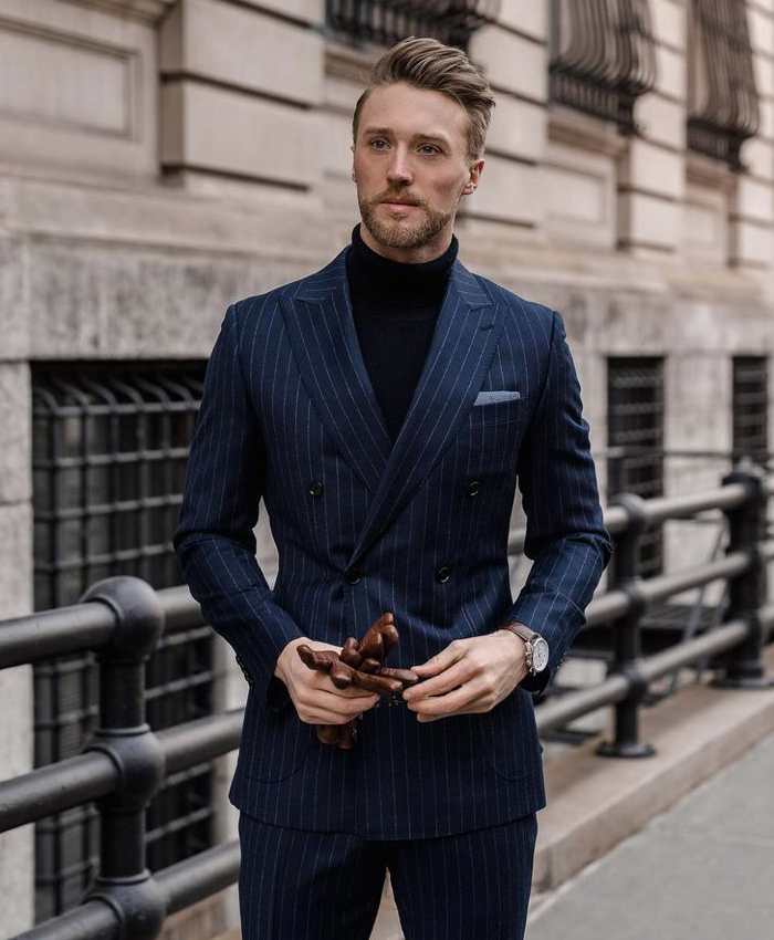 Wearing a navy pinstripe suit with a black turtleneck