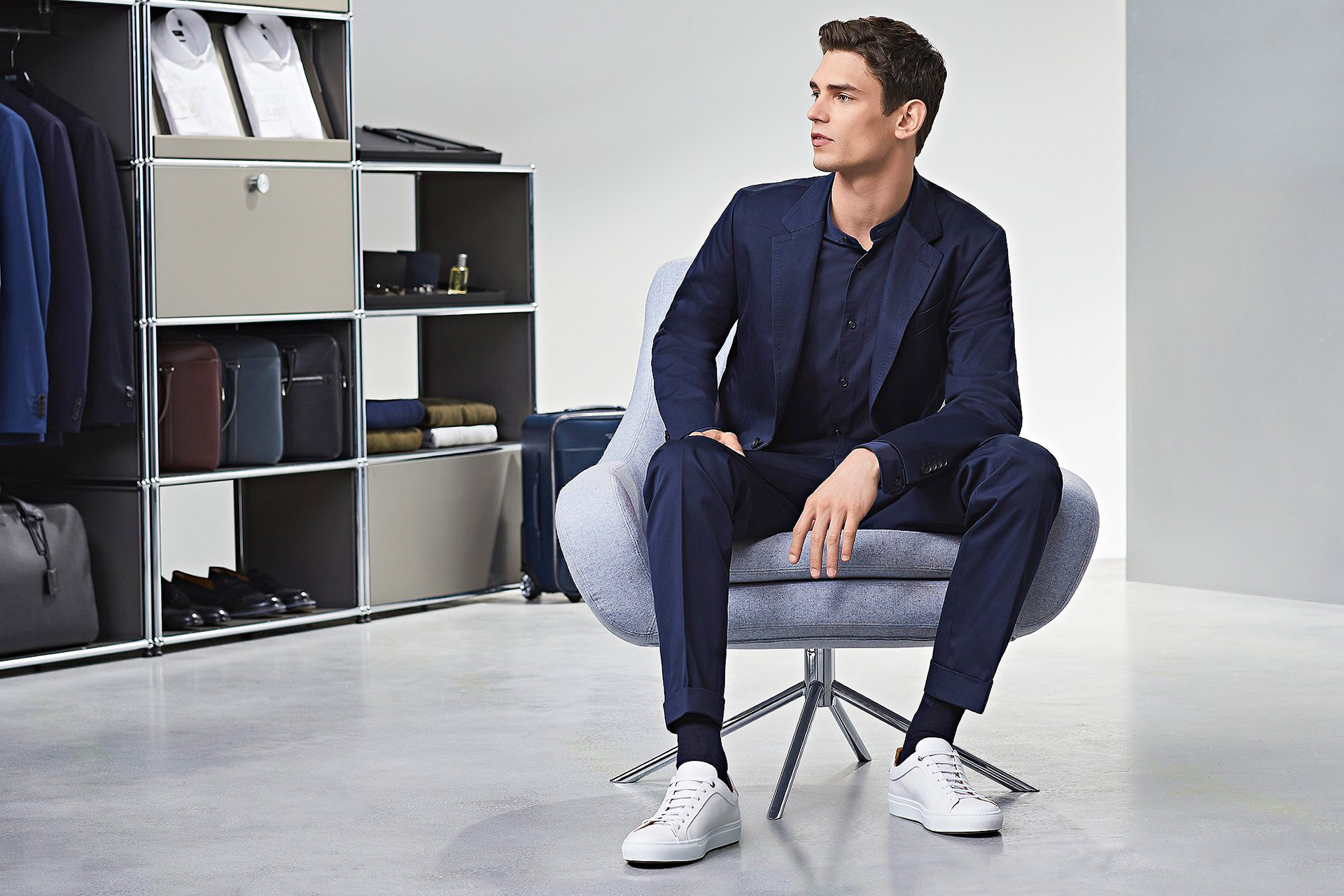 Wearing a navy suit with white sneakers