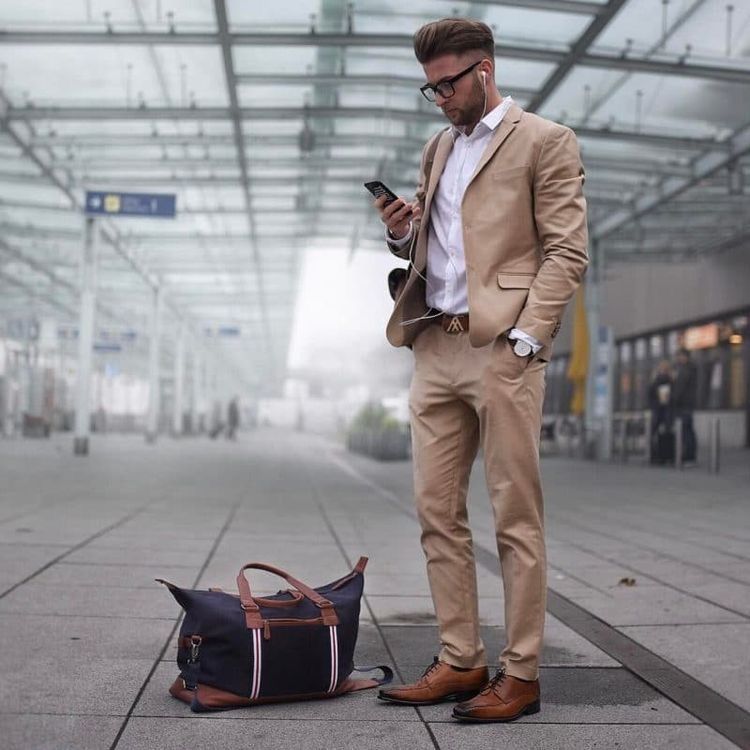 Brown derby shoes with a khaki suit and white shirt