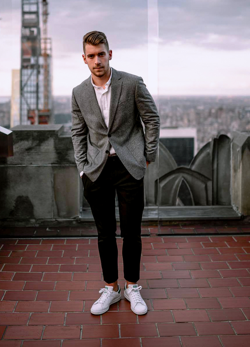 Wearing a charcoal grey blazer with black pants and white sneakers