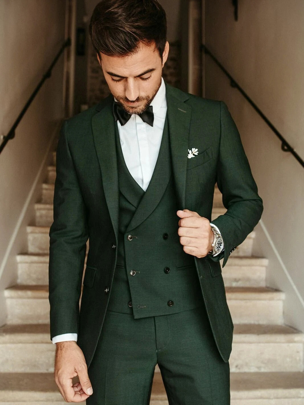 Wearing a dark green suit at a wedding