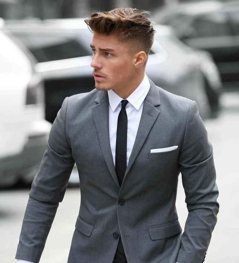 Wearing a medium grey suit and black tie as semi-formal outfit