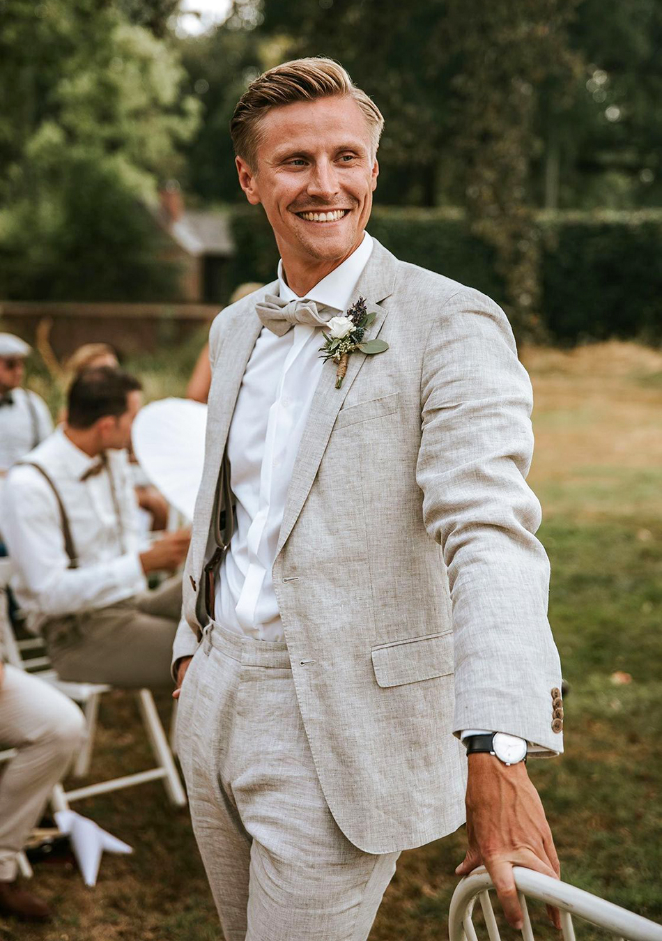 Wearing a tan linen suit and white dress shirt for a wedding
