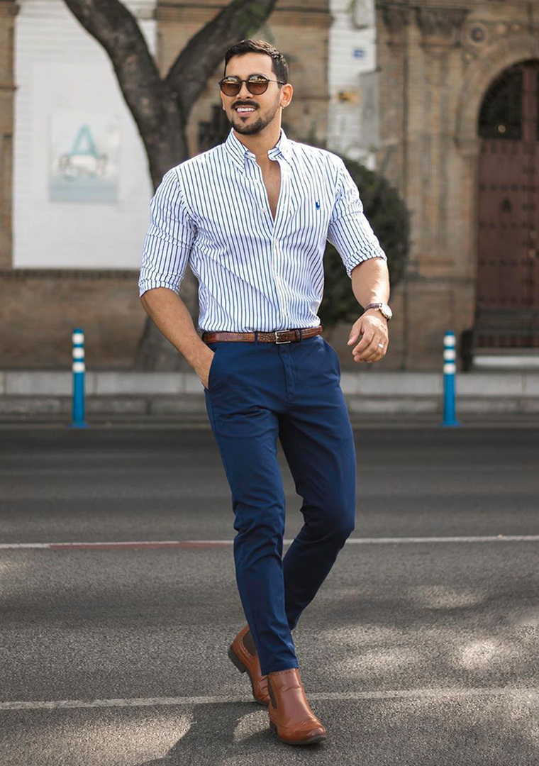 White and blue striped shirt, blue trousers, and light brown Chelsea boots