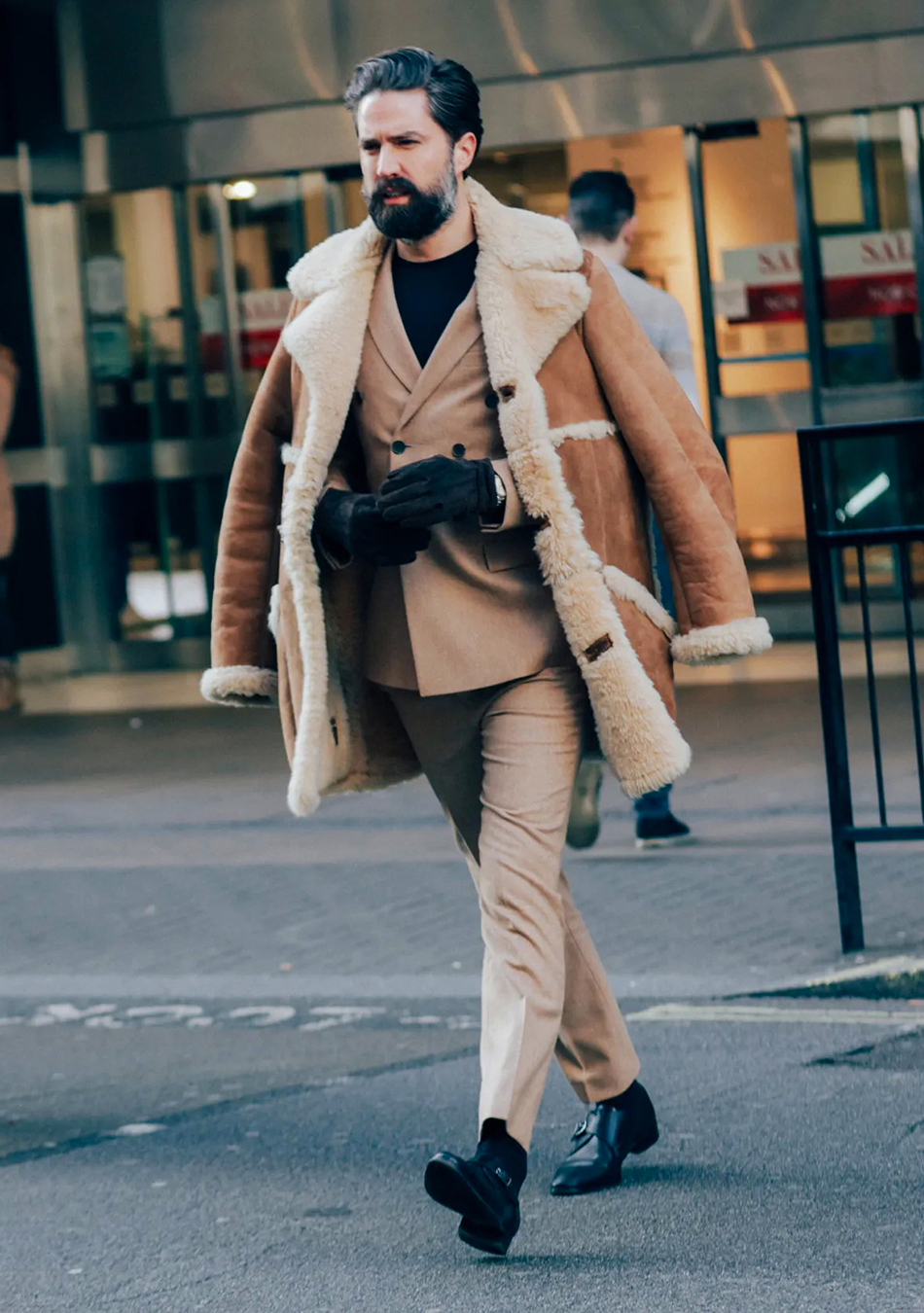 Winter jacket over a tan double-breasted suit